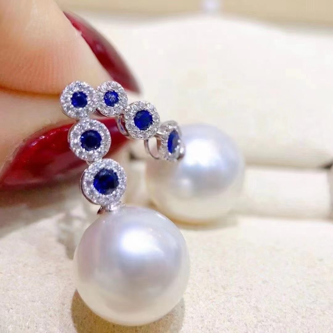 Sterling Silver Perfectly Round Pearl Earrings: Title: Sterling Silver Perfectly Round Pearl Earrings Description: These earrings are crafted from sterling silver, featuring perfectly round pearls that exude elegance. The pearls have slight