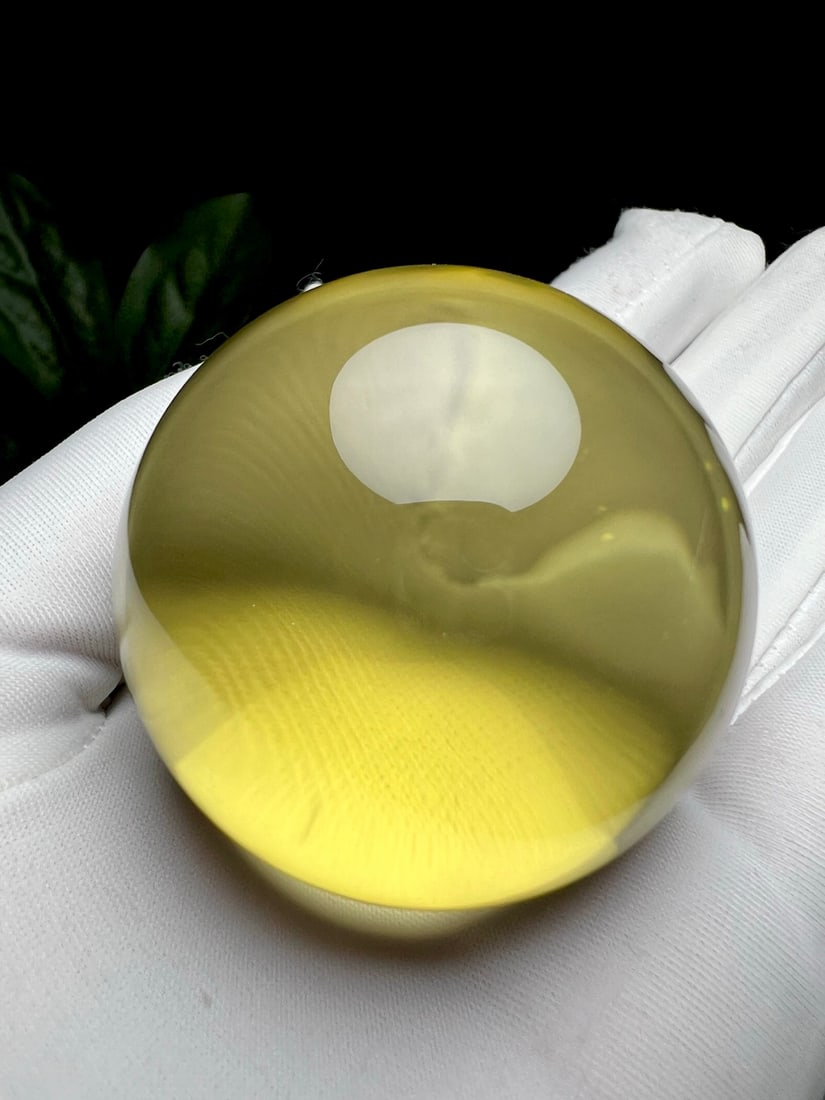 Natural Citrine Ornament: Title: Natural Citrine Ornament Description: This natural citrine ornament showcases a noble and elegant aura with its perfect spherical shape and crystal-clear quality. The unique color and luster