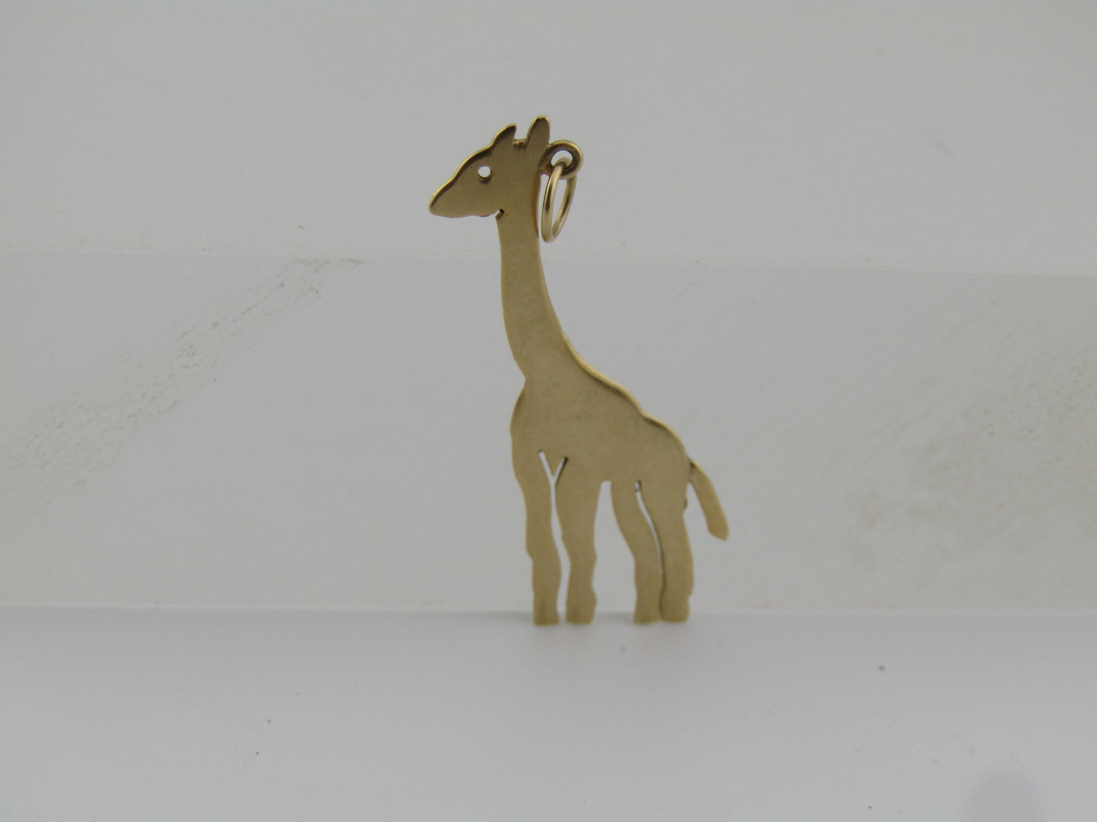 Vintage 14kt Giraffe Pendant, Flat 1970's-1980's, 30mm by 19mm: Title:Vintage 14kt Giraffe Pendant, Flat 1970's-1980's, 30mm by 19mm Description:Vintage 14kt Giraffe Pendant, Flat 1970's-1980's, 30mm by 19mm. This giraffe is flat with a jump ring for sliding your