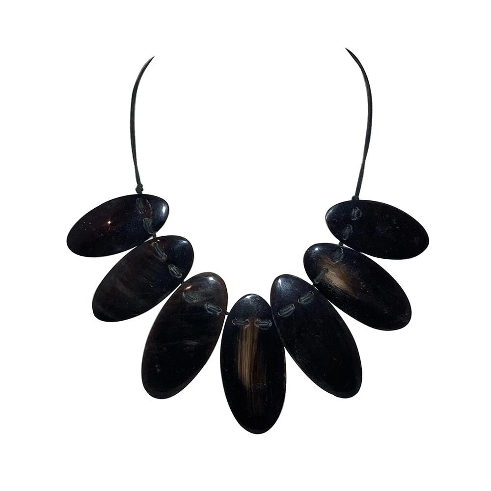Hand Made Carved Cow Horn Necklace: Title:Hand Made Carved Cow Horn Necklace Description:Gorgeous hand made oval cow horn sections Circa, 1980's. Necklace measure 20 1/2" long and 3 1/2" wide. Closes with spring clasp and chain