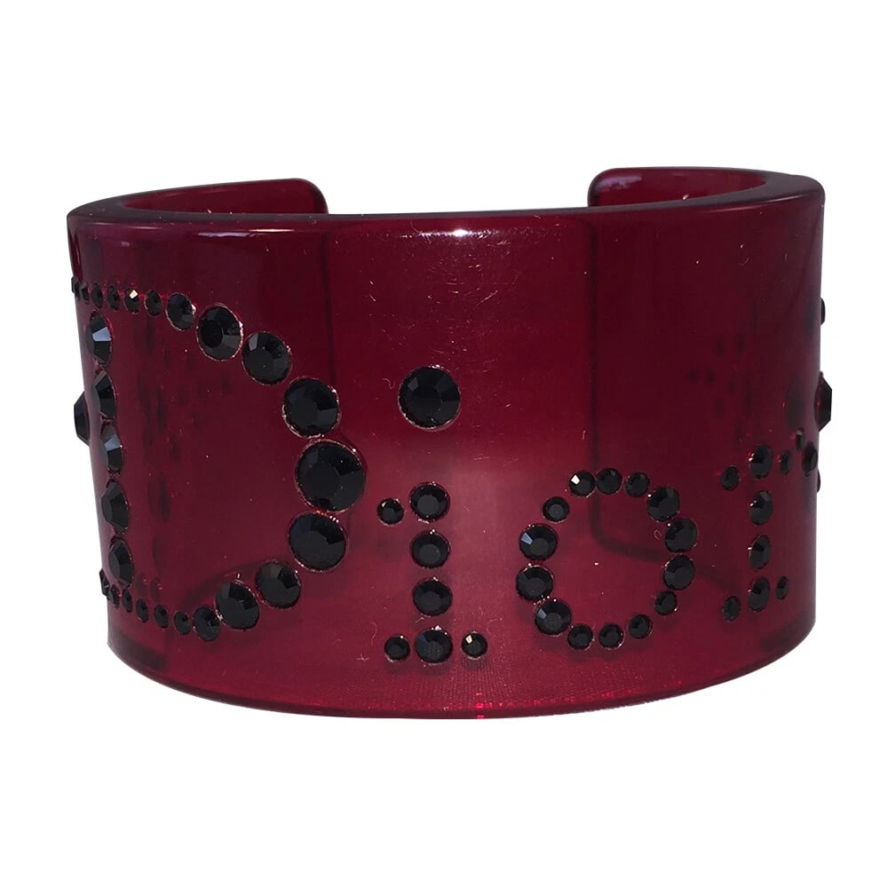 Dior Red Translucent Cuff with Black Rhinestones: Title:Dior Red Translucent Cuff with Black Rhinestones Description:Amazing Dior Red Translucent Cuff with Black Rhinestones. Cuff measures 1 3/4" wide and 2 1/4" by 2" internal measurement. Fantastic