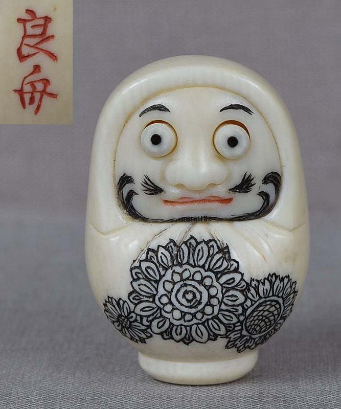 Netsuke DARUMA DOLL by RYOSHU: Netsuke carved by Ryoshu (born in 1912) - one of the best Japanese netsuke carvers of the 20th century. Netsuke represents a doll of Daruma (founder of Zen Buddhism) enveloped in monastic robe, and hi