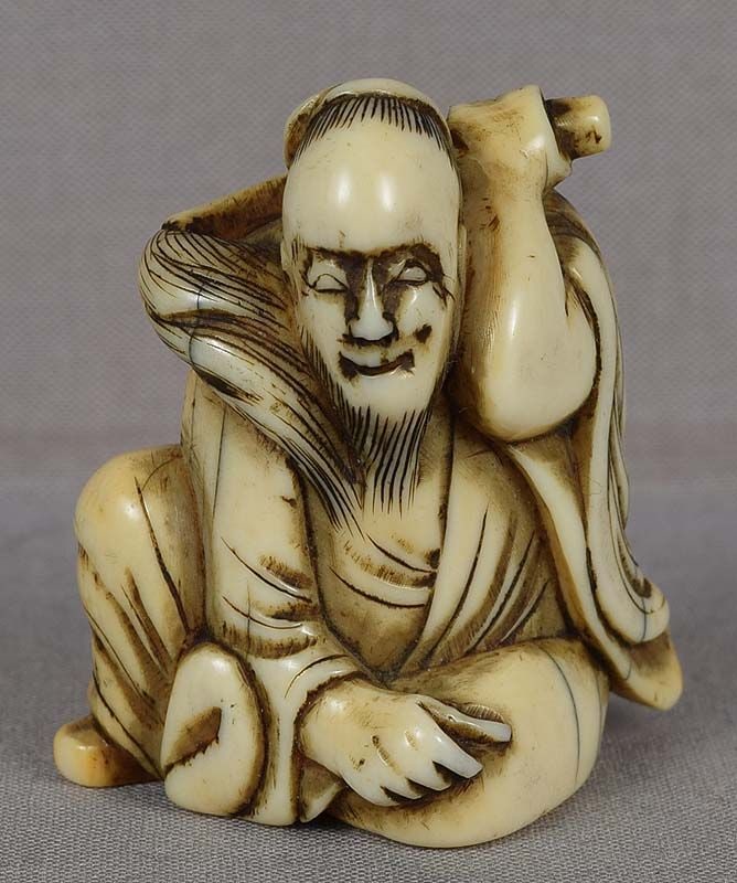 18c netsuke SENNIN CHOCHU with fly whisk: 18th century netsuke of a sennin Chochu enveloped in his robe and holding his most important attribute - a hossu (fly whisk) - across his shoulders. Very rare subject, wonderfully captured facial expr