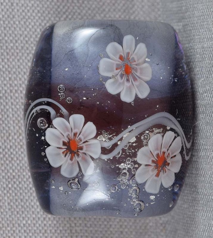 1910s glass OBIDOME netsuke FLOWERS & STREAM: Japanese glass obidome (sash ornament) with flowers floating on a stream with air bubbles and silver foil flakes. Obidome is worn on an obi cord that holds the obi sash together, it is the only type