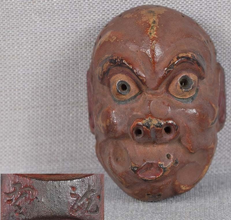 19c netsuke MASK USOFUKI by RYUUN: 19th century Japanese small lacquered wood netsuke representing a theatrical mask of Usofuki with characteristically pursed lips. Crisp detailing, nicely lacquered, great patina. some wear to the surf