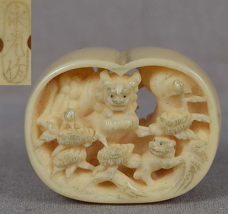 19c netsuke SHISHI FAMILY & peony by NAGAMITSU: Unusual 19th century netsuke in bean shape carved on the inside with a scene of a shishi family (2 adults and a cub) frolicking among flowering peony bushes. Rare use of anabori (cavern) carving
