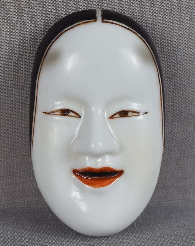 Porcelain netsuke / OBIDOME mask Waka-Onna by KOSUZU: Rather unusual Japanese porcelain obidome / netsuke in a shape of a mask of a female theatrical character Waka-Onna. Obidome is worn on an obi cord that holds the obi sash together, and is the only
