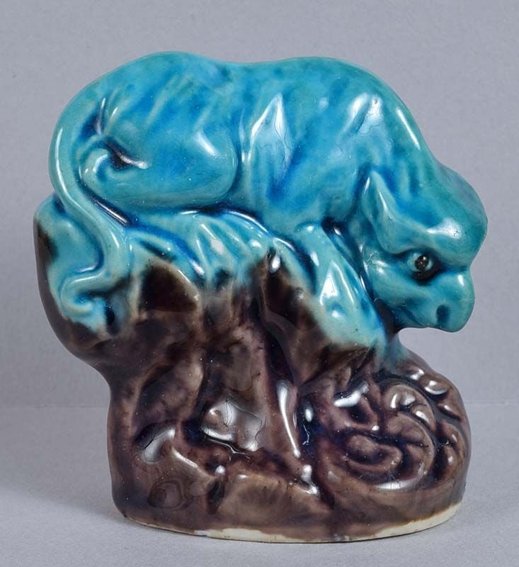 19c Chinese porcelain sculpture MYTHICAL BEAST: Late 19th to early 20th century Chinese porcelain figure of a mythical beast crouching on a rock above cresting waves with its head lowered. Wonderful potting, excellent face, beautiful use of