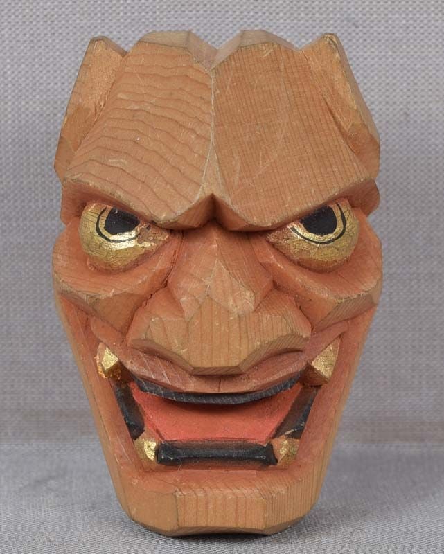 Netsuke DEMON HANNYA mask: Late Meiji wooden netsuke representing a theatrical mask of horned demon Hannya. Cleverly carved out os soft evergreen wood in ittobori (one-cut) style characteristic of Hida school, colors and gold