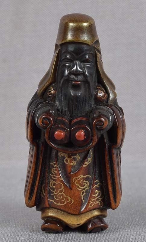 19c lacquer netsuke JUROJIN with scrolls: 19th century lacquered wood netsuke of standing Jurojin (one of the Seven Gods of Good Fortune, that of longevity and wisdom) with a length of cloth in his hands supporting two scrolls. The netsuke is
