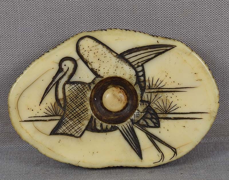 19c marine netsuke CRANE & pines: 19th century marine material netsuke with engraved decoration of a crane taking off by pine saplings and mist. Very nice quality work, beautiful patina, characteristic marine sheen to the surface.