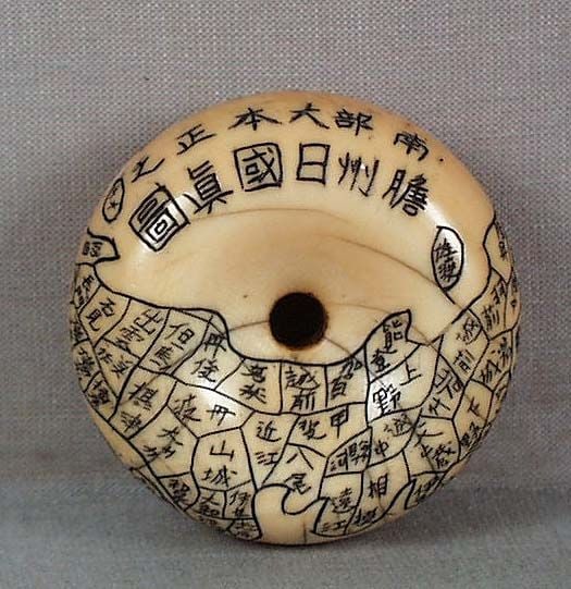 Early 19c netsuke MAP OF JAPAN manner of Nanka: Early 19th century netsuke in manju shape carved with a map of Japanese islands, all prefectures’ names are engraved in minute calligraphy. Very nice work in the manner of Nanka, old age lines,