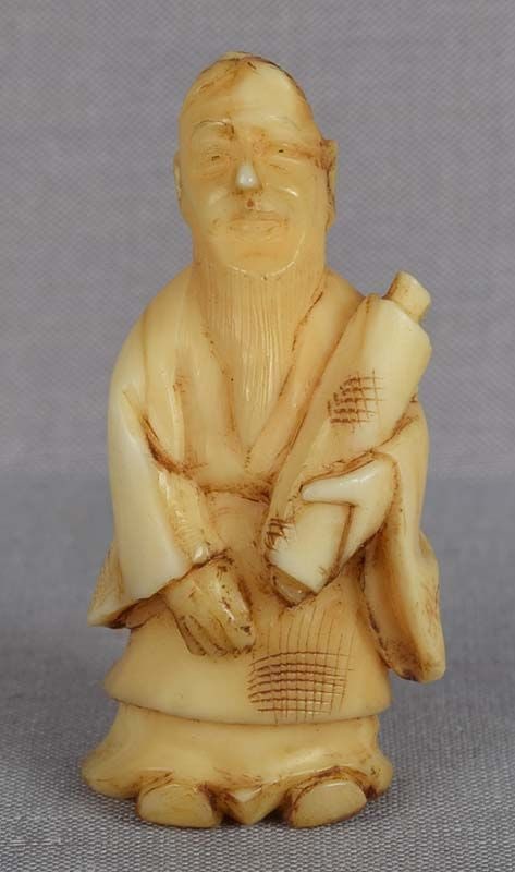 19c marine netsuke SCHOLAR with scroll: Late 19th century marine netsuke of a scholar holding a scroll. Nicely carved, decent face, good patina. Height 1.84 inches. Reserve: $80.00 Shipping: Domestic: Flat-rate of $20.00 to anywhere within 