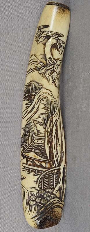 19c ASAKUSA KISERUZUTSU Japanese pipe case SCHOLARLY LANDSCAPE: 19th century Japanese Asakusa school staghorn kiseruzutsu - tobacco pipe case - carved with a scholarly landscape with a temple among hills and rocks by a pine tree, and a village in the distance.