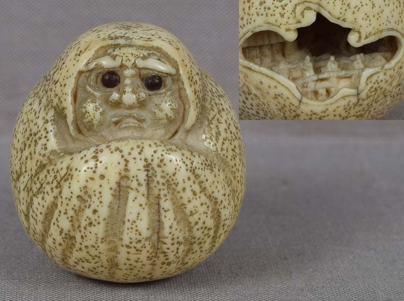 19c netsuke DARUMA doll with landscape inside: Unusual 19th century netsuke of a cloth Daruma doll with wonderful inquisitive face and a shaped opening on the back with anabori (cavern carving) of a palace with a procession of scholars crossing a