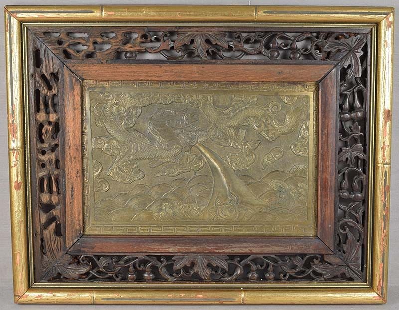 19c Chinese bronze plaque DRAGON in flight: 19th century Chinese bronze f plaque with low relief depiction of a dragon in flight over among swirling clouds above cresting waves, as it exhales its fiery breath towards a monster fish. Very nice