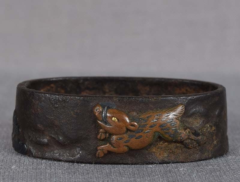 19c Japanese sword FUCHI boar and pines: Early 19th century iron Japanese sword fuchi (bordering piece between the sword guard and the handle) with inlaid multimetal design of a boar running among pine trees. Excellent quality work with gild