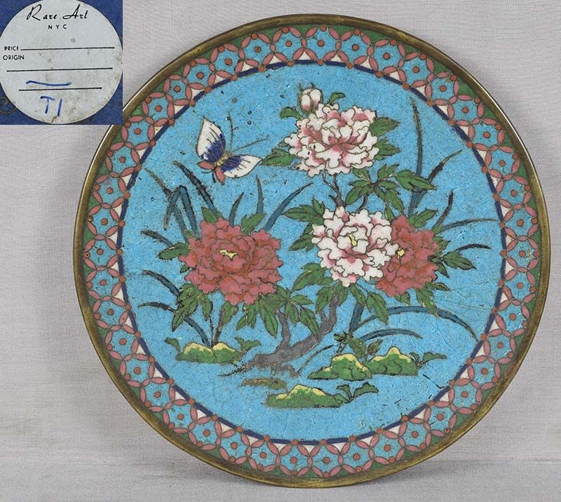 Early19c Japanese CLOISONNE PLATE PEONIES & butterfly ex Rare Art Inc.: Early 19th century Japanese cloisonne plate decorated with a butterfly in flight over blooming peony bushes, all within a brocade border. Rare Art Inc. sticker on the back, bold powerful design, rare