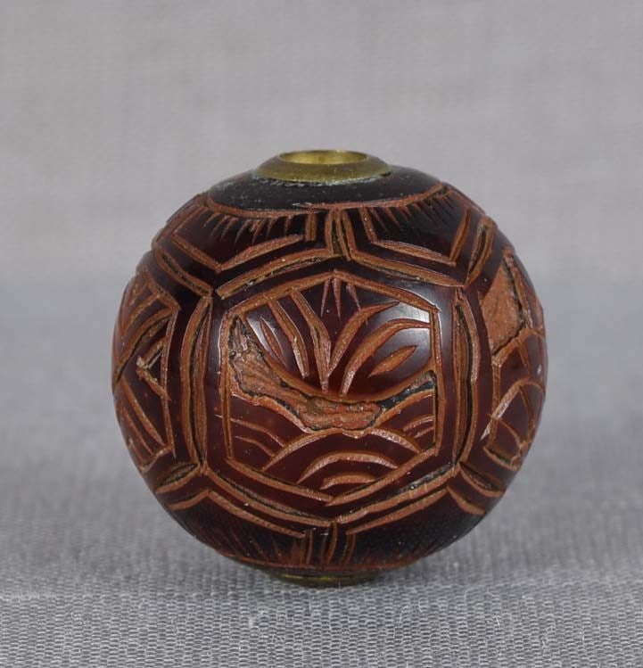 19c lacquer OJIME netsuke slide WAVE PATTERNS: 19th century lacquer ojime (slide bead for tightening the cord going from netsuke to inro) of ball shape carved with 5 hexagonal reserves, 3 with different wave patterns and 2 with geometric ones. Won