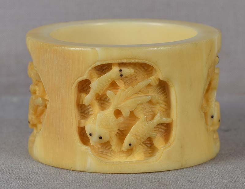 19c Chinese export NAPKIN RING various fish: 19th century Chinese export napkin ring carved on the outside with three reserves containing different fish among waves, each fish has eyes inlaid with black horn. Wonderful work with deep