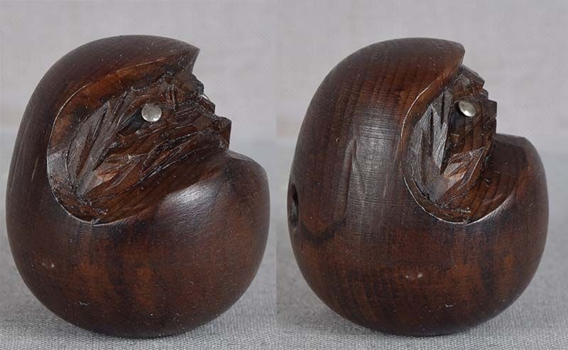 19c netsuke Hida school DARUMA: Late 19th century wooden netsuke of Daruma (the founder of Zen Buddhism) enveloped in his monastic robe. The subject represents Daruma coming back from deep trance in which he sat meditating without m