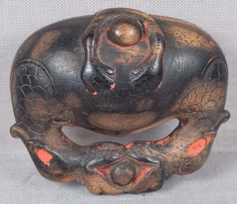 19c netsuke MONK asleep in Buddhist gong: Unusual 19th century wooden netsuke carved as a Buddhist monk (recognizable by its shaved head) fast asleep, lower half of its body inside a huge Buddhist gong. The subject is a metaphor for a failure
