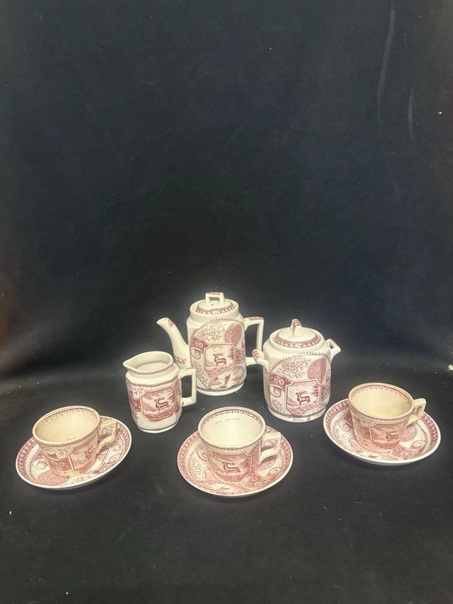 9pc Childs Stag Staffordshire Teaset: The teapot is 5 1/8" high, the sugar is 5 1/4"high, the creamer is 4 5/8" high, the saucer measures 4 5/8" and the cup measures 2 1/8" x 3 1/8". One cup has a faint 1/2" hairline. Otherwise it has no
