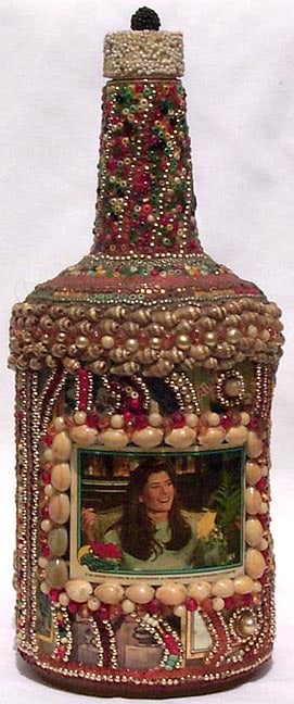 A memory bottle decorated with beads, shells, and trading card - 2
