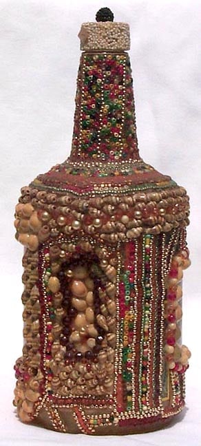 A memory bottle decorated with beads, shells, and trading card - 4