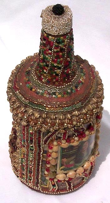 A memory bottle decorated with beads, shells, and trading card - 5