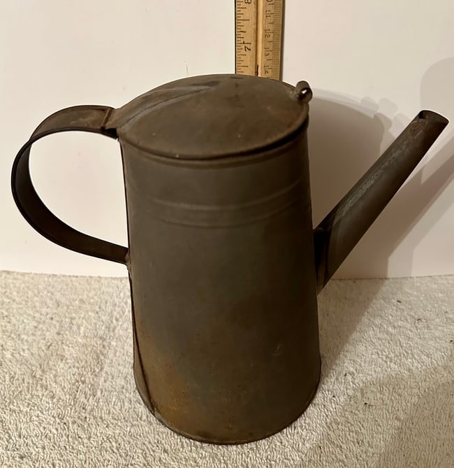 7" Tin Coffee Pot, 19th Century: A medium-sized (6 3/4" high) American Tin Coffee Pot from the late 19th century, perhaps a bit earlier. The pot is 3 1/4" in diameter at the top and 4 3/4" in diameter at the base and the spout is 4