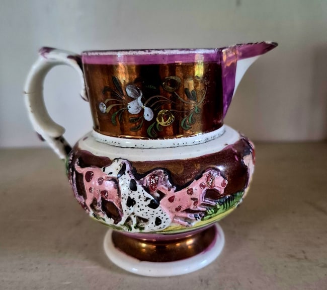 Early English small lustre pitcher: Copper and pink lustre pitcher with polychrome. Three hunt-related embossed designs. A lot of detail. 3 1/2" high. Some white glare in the photos. Shipping: Domestic: Shipping rates are determined by