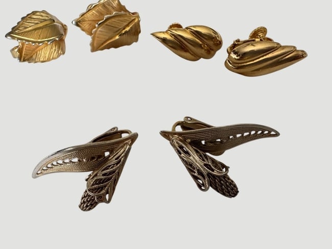 Vintage Lot mid century GIOVANNI Clip on 3 pairs of Earrings: The product is a set of three pairs of vintage mid-century earrings by the brand one pr Giovanni. The earrings feature a leaf shape in a gold color, with a clip-on closure for easy wear. Made in the