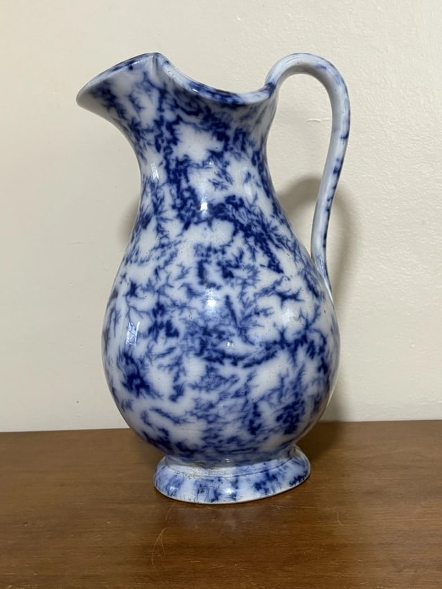 Marble Flow Blue Pitcher: It is 12 1/2" high and dates around the 1850's. It has a small flake on the top rim, a small spot of discoloration and three craze lines that do not go through. Otherwise it has no other issues. It