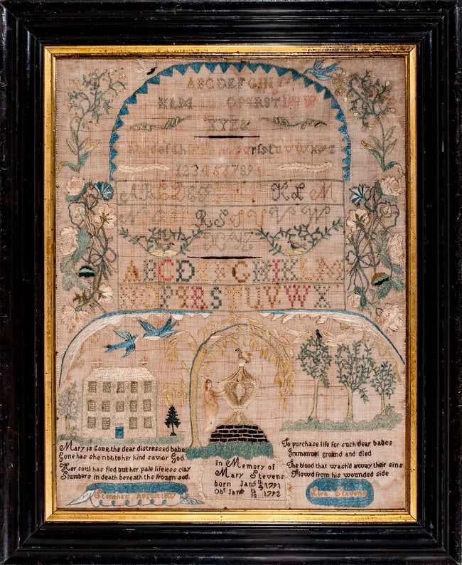 NEEDLEWORK SAMPLER - 1807 - SHONEHAM, MA: Lora Stevens, at age 18, worked this very decorative sampler featuring alphabets within an arched saw-tooth and flowering vine border at the top, and a three-story, center-hall house and monument with