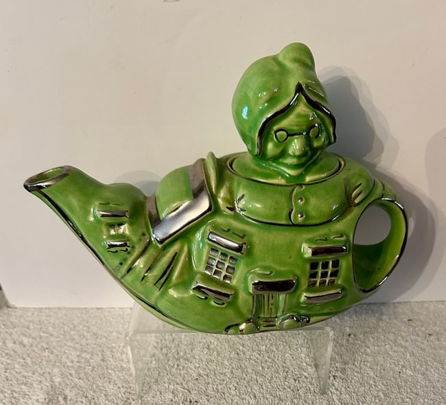 Lingard Pottery Teapot: "Old Lady in a Shoe": A novelty tea pot by Lingard Pottery of England in the form of a shoe house with the Old Lady's head serving as the teapot lid. Lingard is known for its whimsical (novelty) teapots, and this one