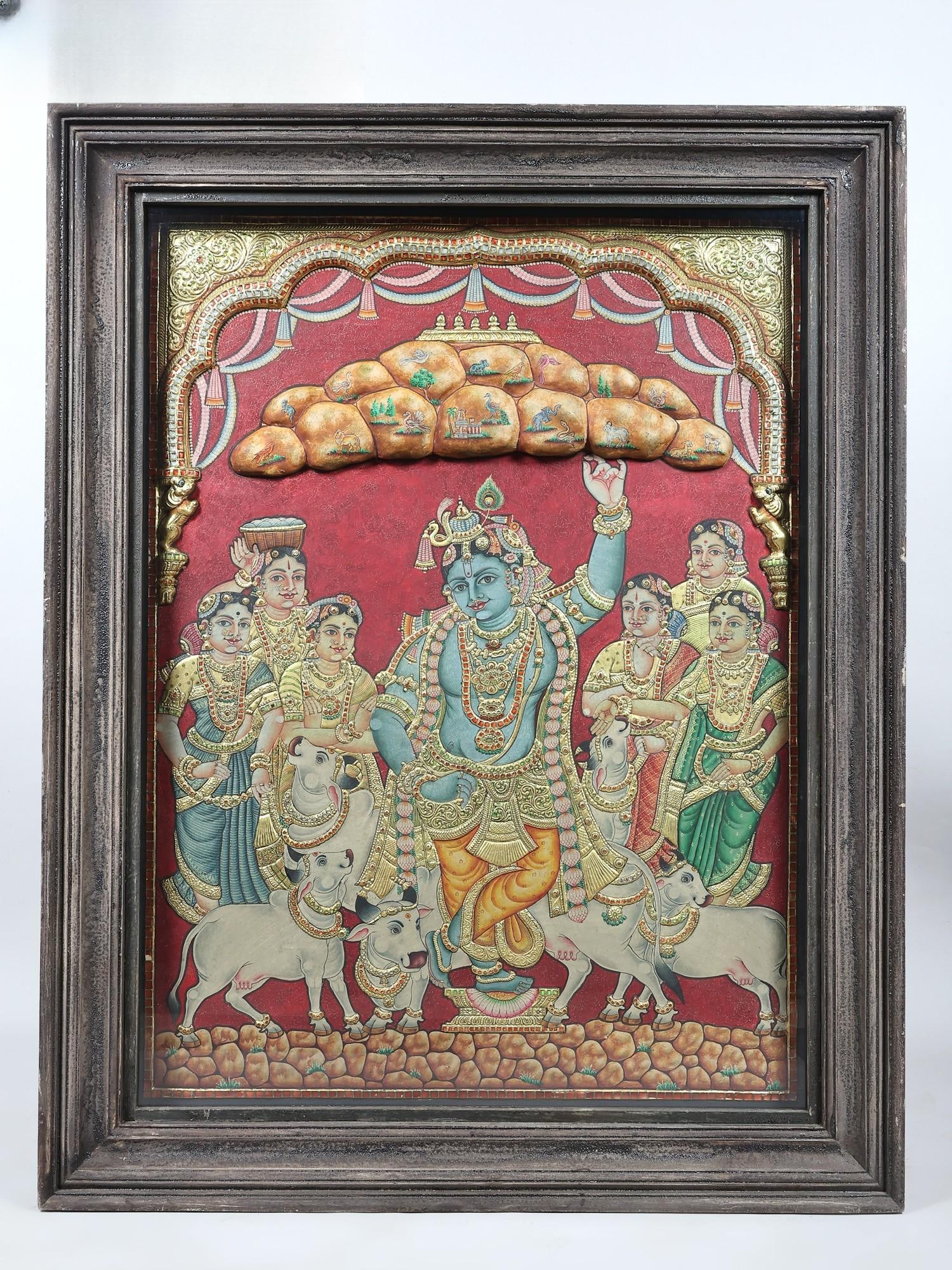 Lord Krishna Holding Govardhan Parvat on his Little Finger | 24 Karat Gold Work | Embossed Three: Title: Lord Krishna Holding Govardhan Parvat on his Little Finger | 24 Karat Gold Work | Embossed Three Dimensional Vintage Tanjore Painting Description: Tanjore (Thanjavur) Painting Reserve: