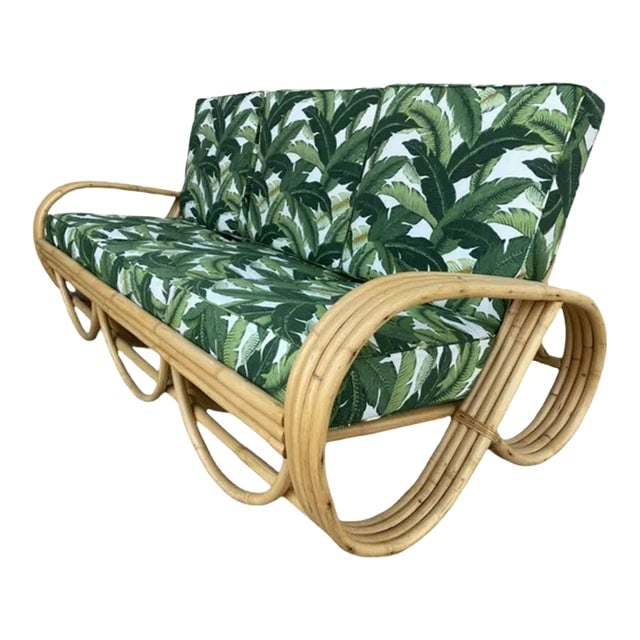 Restored Mid-Century 4-Strand Rattan 3/4 Reverse Pretzel Sofa W/ Arched Base: Title: Restored Mid-Century 4-Strand Rattan 3/4 Reverse Pretzel Sofa W/ Arched Base Description: Four-strand 3/4 reverse pretzel rattan sofa featuring a decorative scalloped detail on the base.