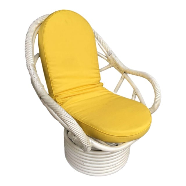 Restored White Rattan Bucket Lounge Chair With Swivel Base: Title: Restored White Rattan Bucket Lounge Chair With Swivel Base Description: Classic rattan bucket seat featuring a circular height carved with two armrests fixed to a round stacked rattan swivel