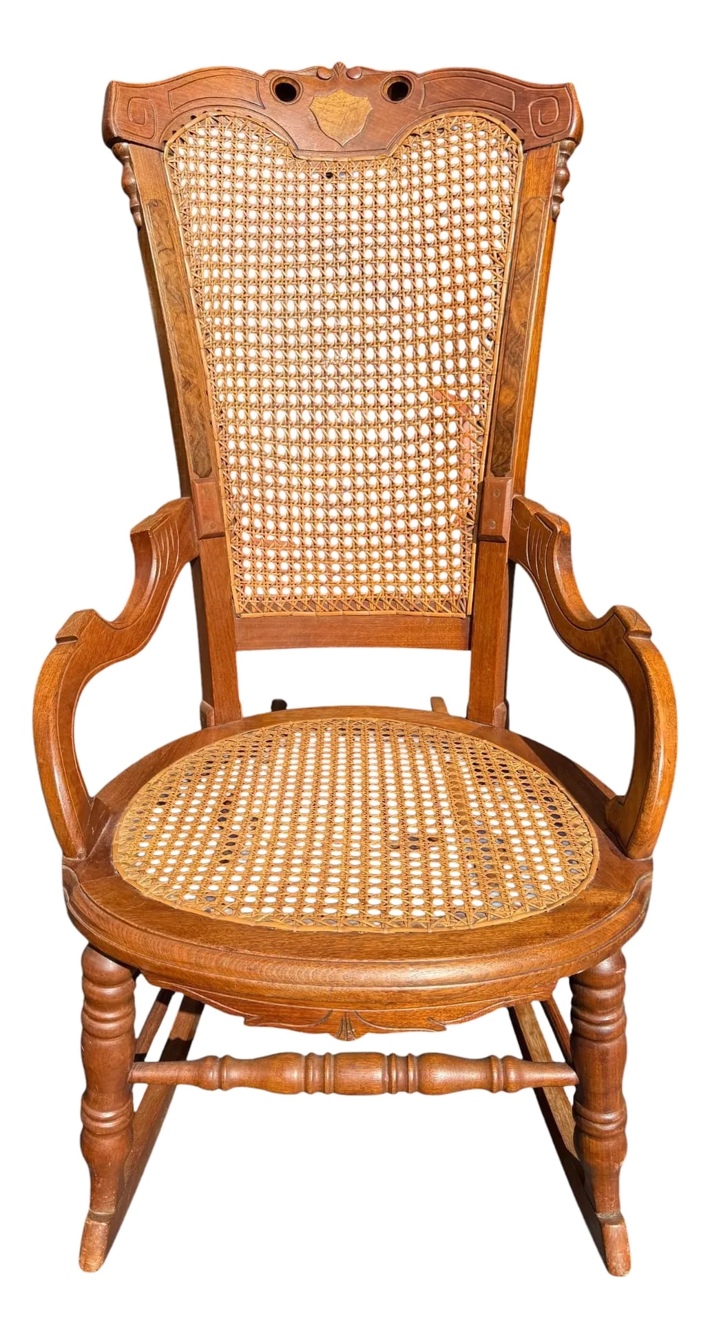 Late 19th Century Victorian Walnut Caned Rocker: Quick Hits: Late 19th century Victorian walnut rocker Petite size with deep, angular rockers Carved back with burl wood inlay Original cane seat and back Perfect for a cozy reading nook or vintage