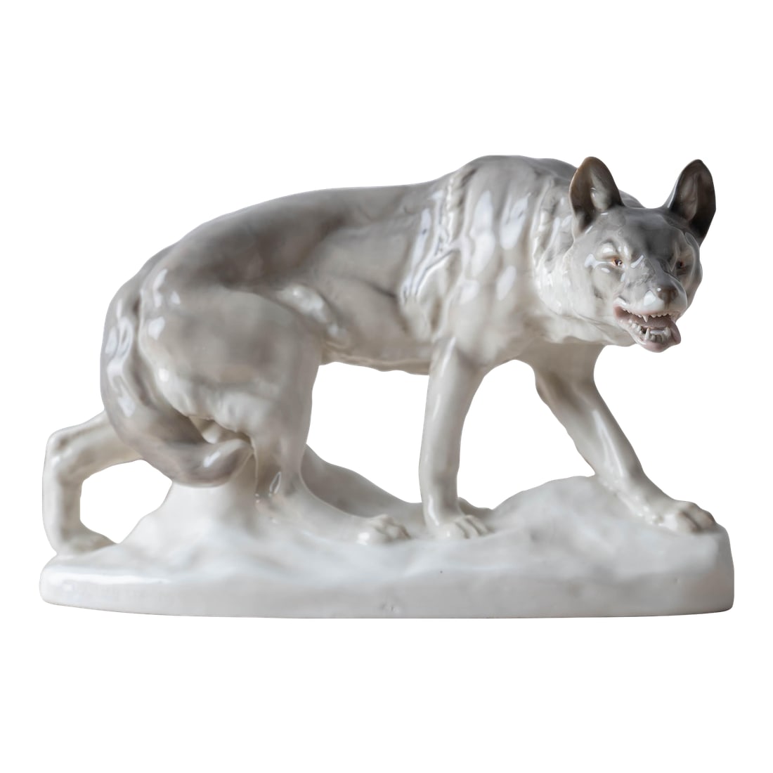 Porcelain Wolf by Waldemar Lindström for Rörstrand: A porcelain sculpture of a wolf by Waldemar Lindström for Rörstrand, early 20th century. Impressed signature to plinth. 11 inches wide by 6 Â½ inches deep 7 inches tall Condition: