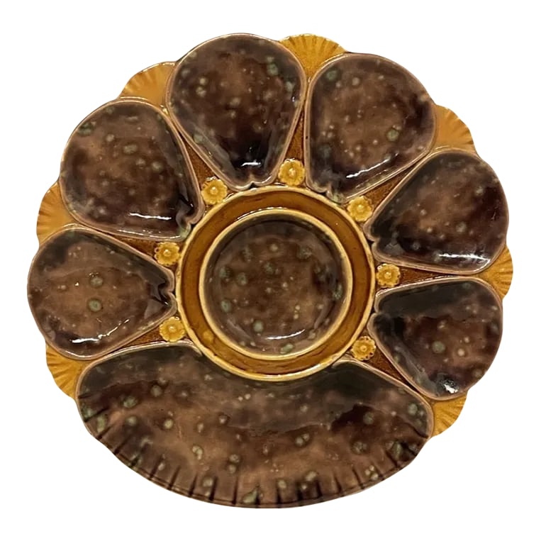 19th Century English Majolica Oyster Plate: A good 19th century English Majolica Oyster Plate, unusual brown color, with green back. Marks on the back 2239. The plate is in good condition measuring 10" diameter. C. 1880. No chips nor hairline