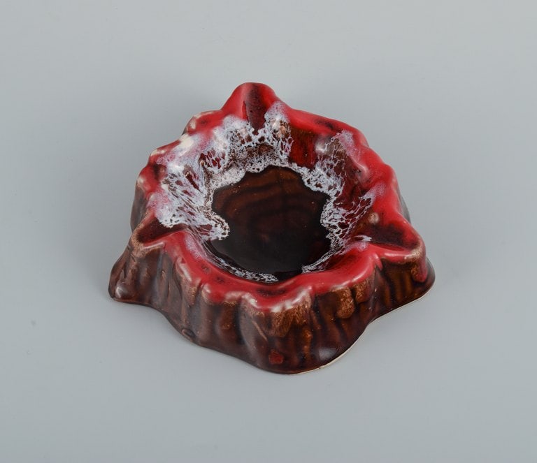 Vallauris, France, two ceramic bowls in brightly colored glazes in red and orange on a dark brown - 3