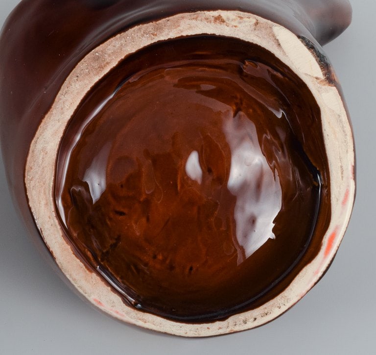 Vallauris, France, two ceramic bowls in brightly colored glazes in red and orange on a dark brown - 7