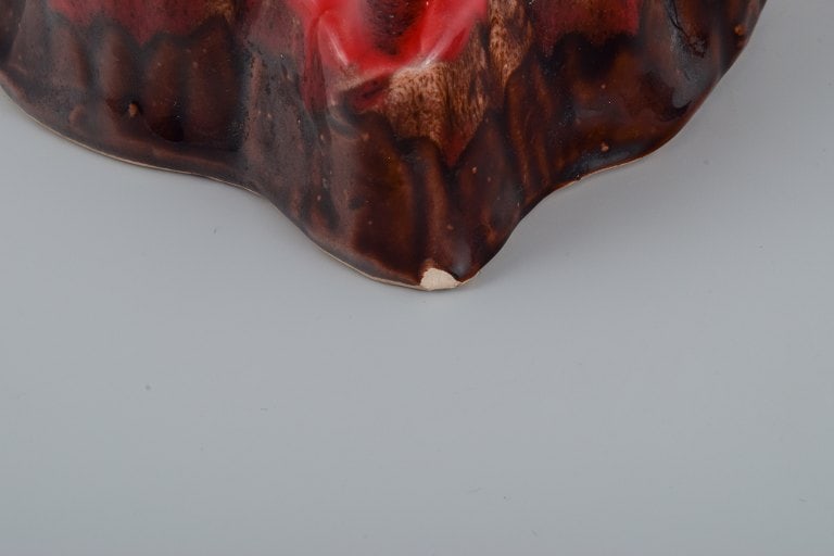 Vallauris, France, two ceramic bowls in brightly colored glazes in red and orange on a dark brown - 8