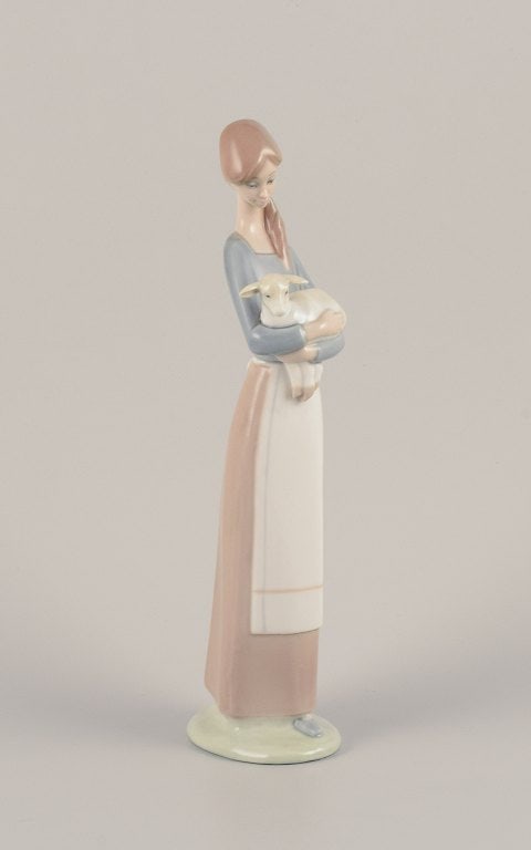 Lladro, Spain. Porcelain figurine of a standing young woman holding a lamb in her arms. - 2