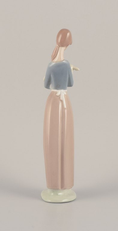 Lladro, Spain. Porcelain figurine of a standing young woman holding a lamb in her arms. - 7