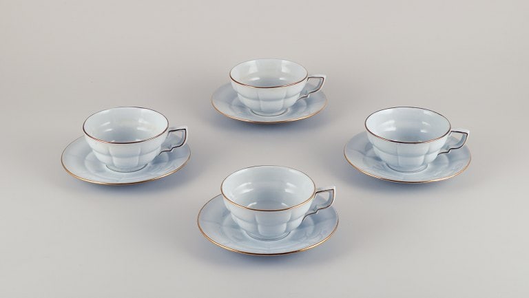 Gefle, Sweden, a set of four "Grand" Art Deco teacups with saucers. Light blue faience with gold: Gefle, Sweden, a set of four "Grand" Art Deco teacups with saucers. Light blue faience with gold trim. Approximately from the 1940s. Partially marked. In excellent condition. Cup: Diameter 10.6 cm