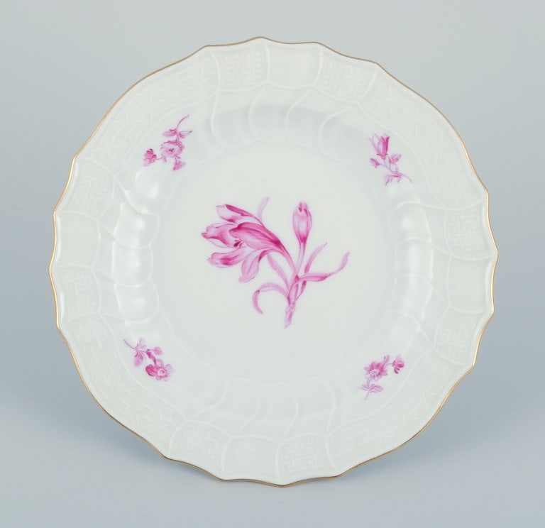 Meissen, Germany. A set of seven porcelain plates hand-painted with purple flower decoration and - 7
