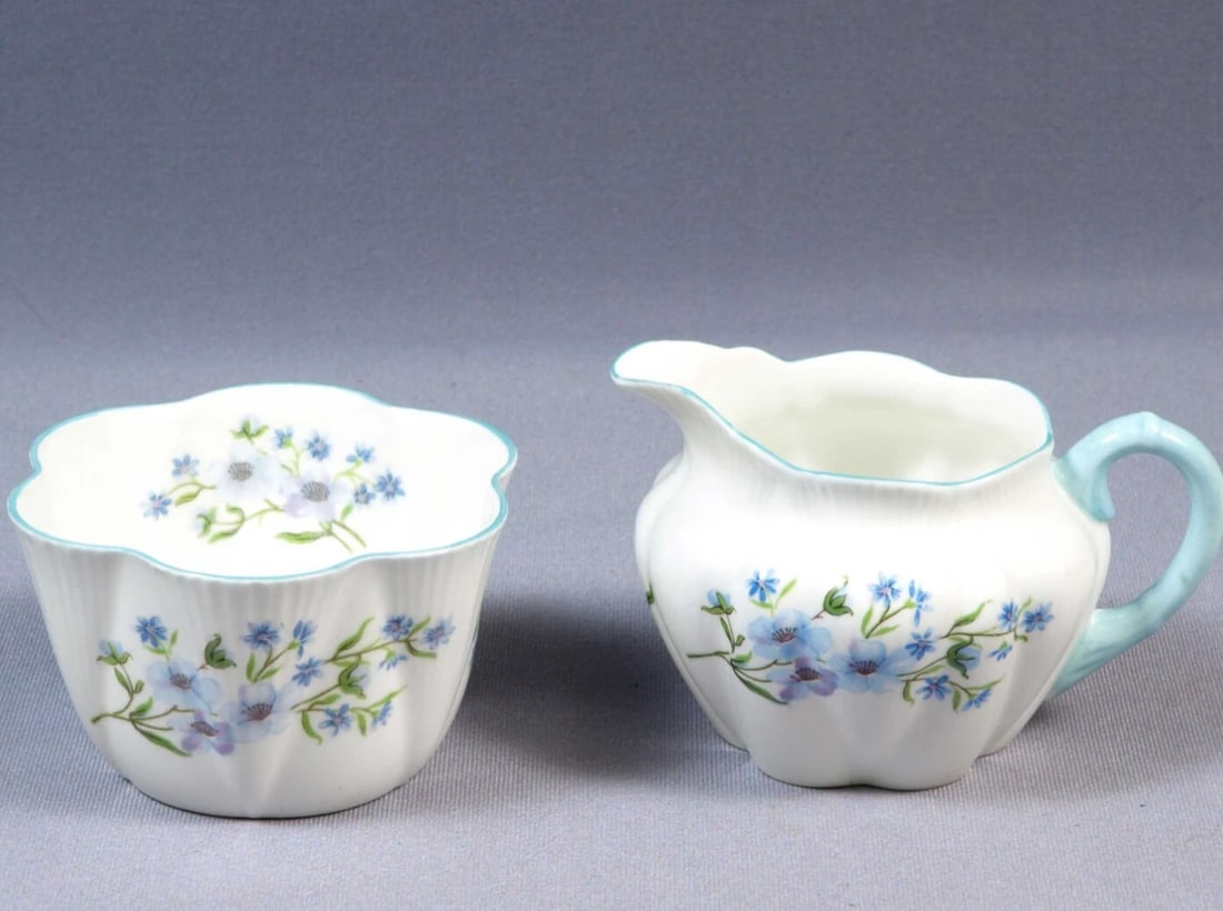 Shelley BLUE ROCK Dainty Shape Creamer Jug Milk Sugar Bowl Set Bone China 272101: This is a beautiful and timeless Fine Bone China Creamer and Sugar Bowl, made by Shelley England in Blue Rock pattern. The set is in the Shelley famous Dainty shape with blue rim. It is is properly ma